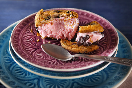 Delicious cookies with ice cream and chocolate chips on plate