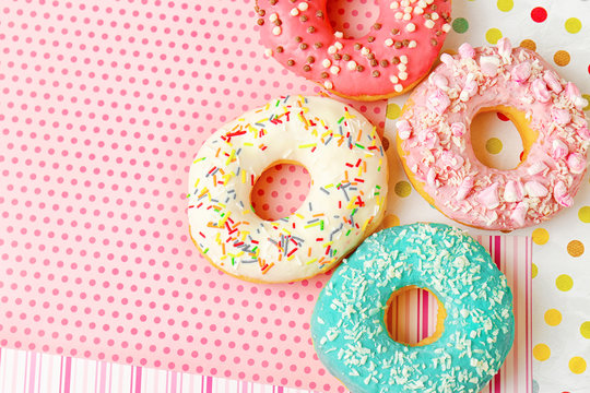Delicious donuts on colorful background