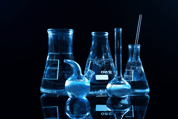 Test beakers and flasks on dark background