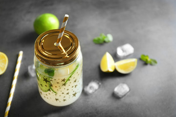 Lime lemonade in mason jar on color background