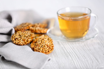 Cereal cookies with cup of tea on wooden table