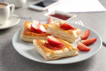 Sweet tasty pastries on plate on table