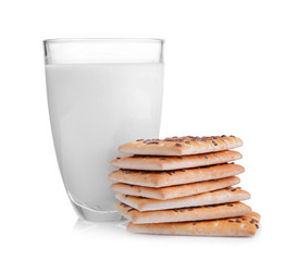 Delicious cereal cookies with glass of milk on white background