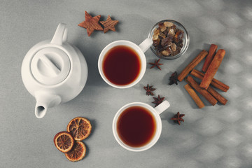 Hot tea with aromatic ingredients on kitchen table