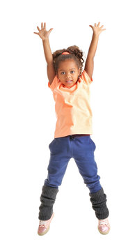 Cute African American girl jumping on white background