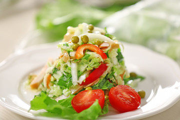 Plate with salad on table