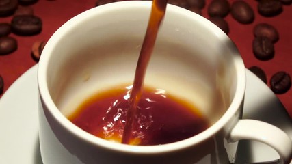 Pour black coffee in white cup. Slow motion - Powered by Adobe