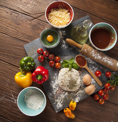 Preparing pizza with dough and tomato sauce