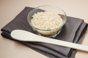 Plate and wooden spoon with white rice