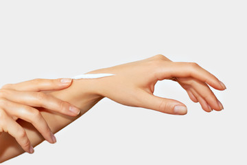 Woman Making her Skin Clean and Smooth. Close-up of Woman Applying Cream on Hand