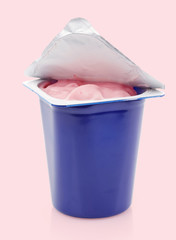 fresh pink berry yogurt in blue plastic pot