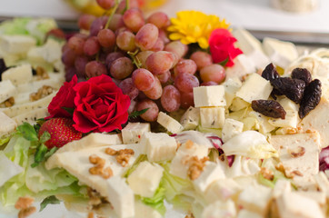 Cheese with flowers on wedding table
