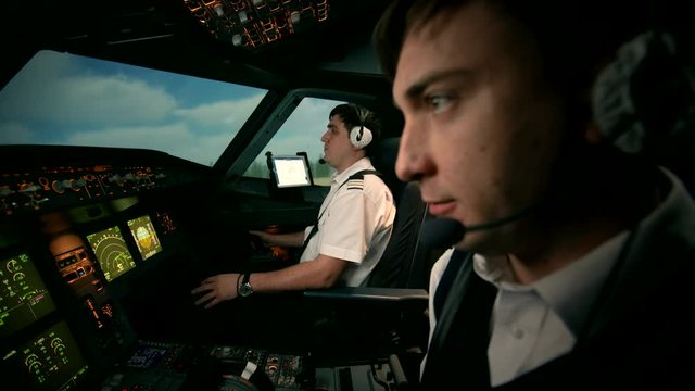 Side view of Airbus A319 A320 A321 flight deck during takeoff. Airplane is running on the runway of airport and then take off and departure. Pilot-In-Command, co-pilot in the cockpit of modern