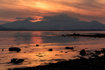 Sunset on Fenit Island looking across Tralee Bay towards the Dingle Peninsula, County Kerry, Ireland