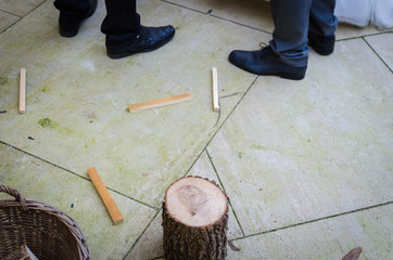 Man on wedding day with axe versus wood