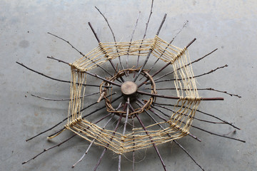 Web like sculpture of wood, twigs, vines, and sisal twine