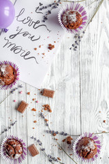 concept of Valentine's Day cupcakes wooden background top view