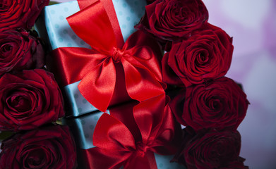 Red roses and gift box, love background