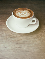 Cup of cappucciono coffee at  cafe. Vintage filter style blur pe