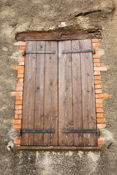 wooden shuttered window of an old house