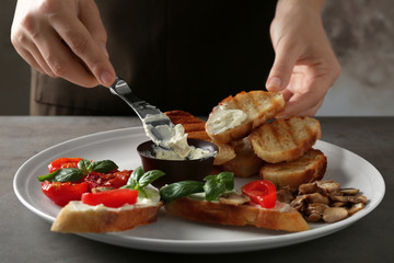 Woman cooking tasty bruschetta, closeup