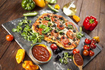Delicious pizza served on wooden table