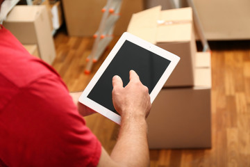 Young businessman with tablet at warehouse, closeup