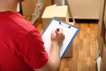Young businessman with clipboard at warehouse