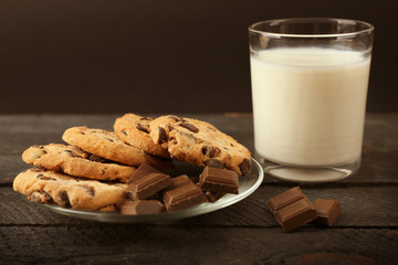 Chocolate cookies with milk on table