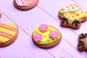 Decorative gingerbread Easter cookies on pink wooden background