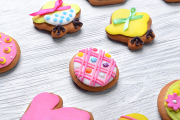 Decorative gingerbread Easter cookies on white wooden background