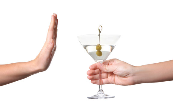 Hand of woman refusing glass with alcoholic beverage, on white background