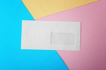 Blank white envelope on color paper background