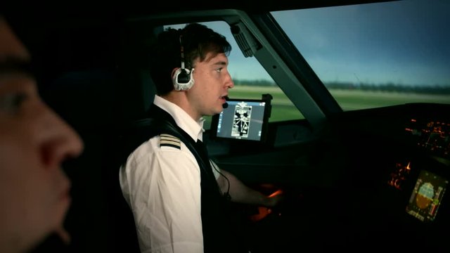 Side view of Airbus A319 A320 A321 cabin. Airplane is taxiing on the runway of airport. Captain and co-pilot perform pre-flight procedure to be rady take off and departure.