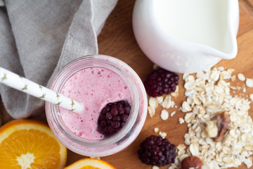 pink smoothie in a glass bottle, milk jug with milk top view