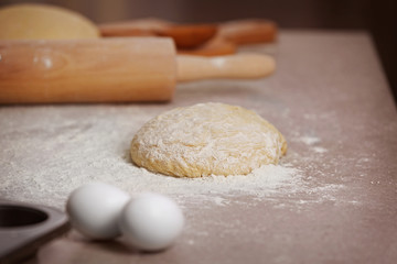 Fototapeta na wymiar Fresh raw dough on kitchen table