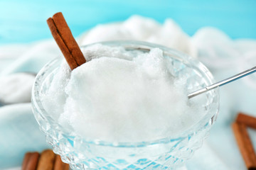 Melting snow in crystal bowl on blurred background
