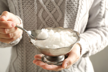 Crystal bowl with snow in female hands, closeup