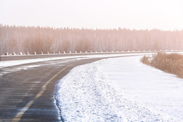 Obraz premium View of winter road on sunny day