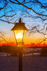 illuminated old street lamp in winter landscape