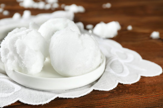 White Plate With Snow Ice Cream On Wooden Table