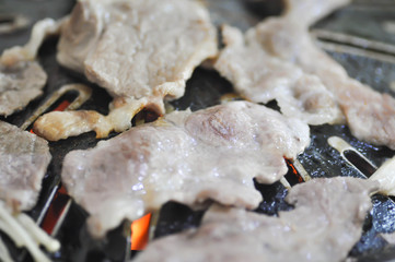 grilled pork on charcoal brazier in Korean style