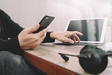 man hand using VOIP headset with digital tablet computer docking