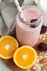 pink smoothie in a bottle on a tray top view