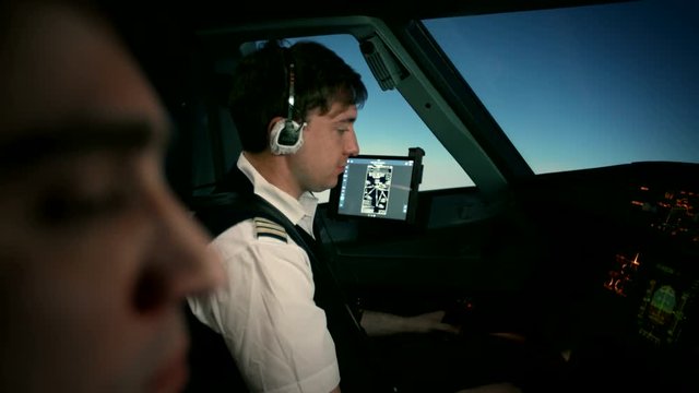 Captain and copilot in the flight deck of a passenger aircraft during the flight. Airbus A319 A320 A321 at the course