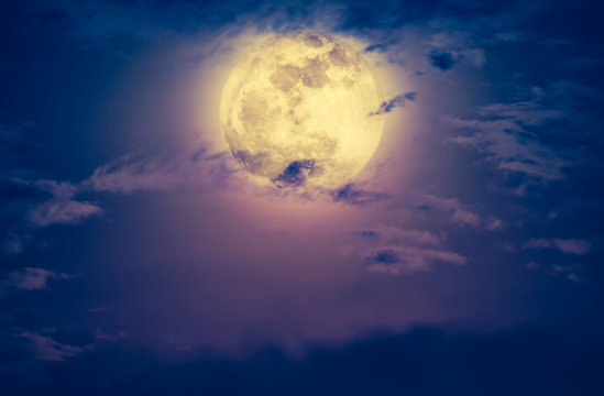 Nighttime sky with clouds and bright full moon. Vintage effect tone