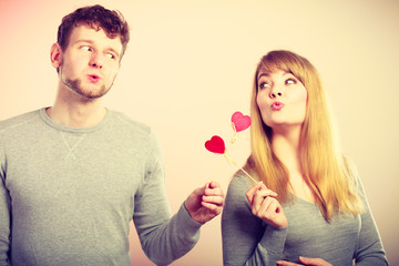 Loving pare with hearts flirting.