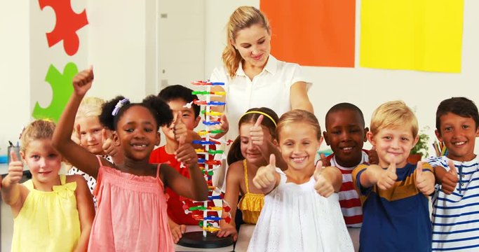 Portrait of kids and teacher doing thumbs up in laboratory at school 4k