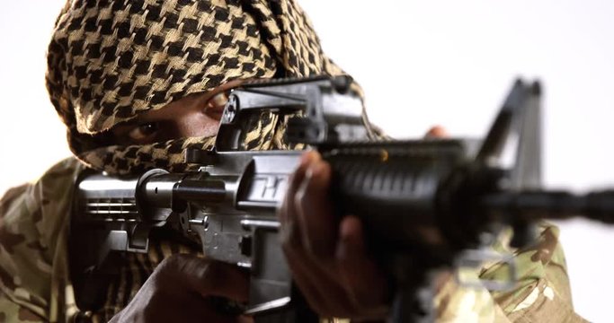 Terrorist aiming with machine gun against white background 4k