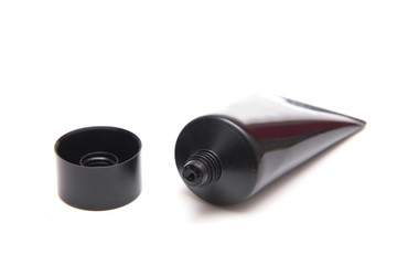 Skincare in black plastic tube isolated on white background